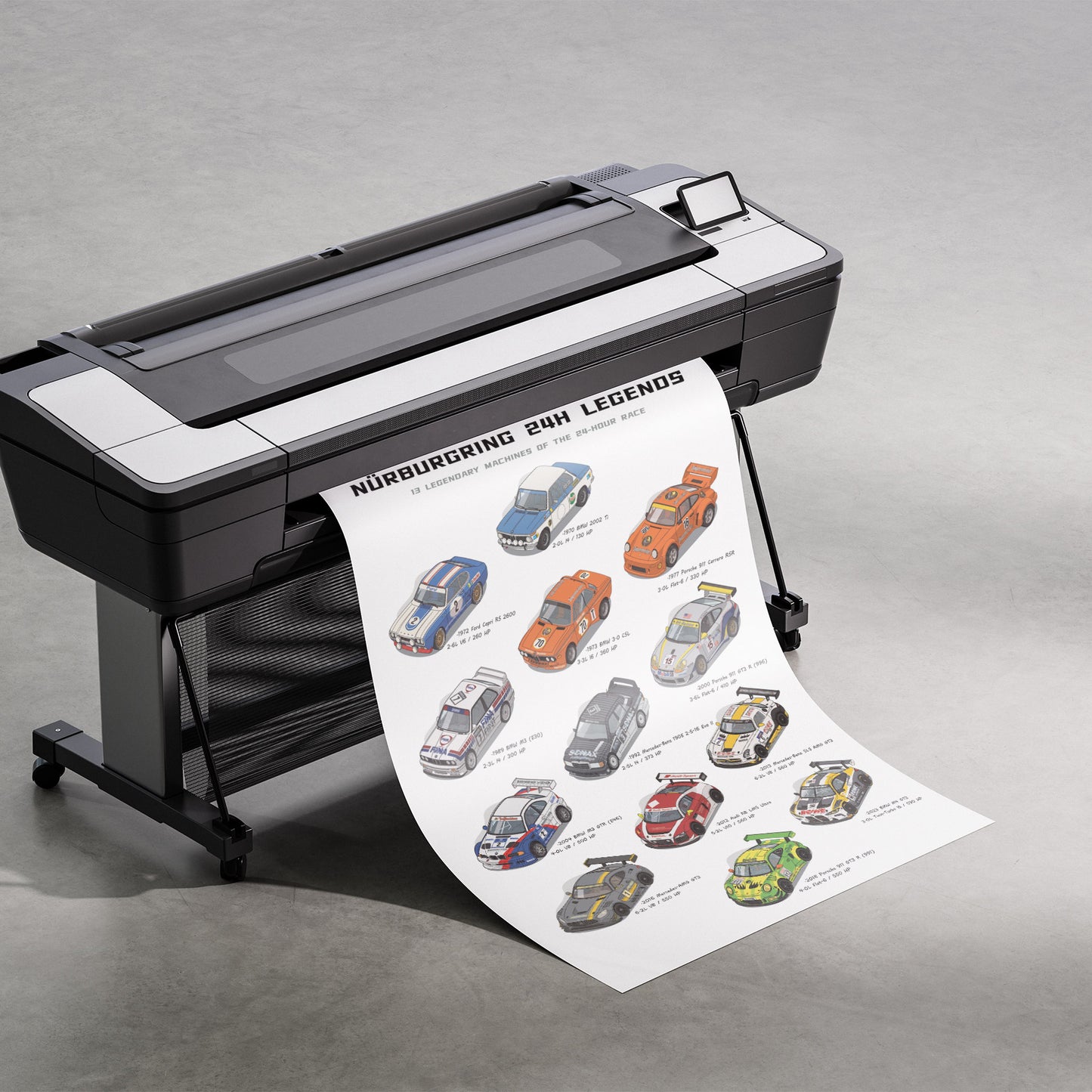 A large black and white industrial flatbed printer on a stand, printing and displaying a long sheet of poster art titled 'Nurburgring 24H Legends' with illustrated race cars, set against a gray concrete floor.