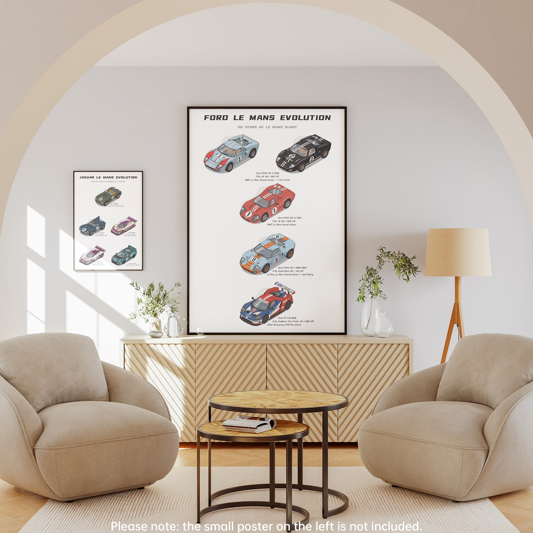 A framed vertical poster titled 'Ford Le Mans Evolution' hangs on a light gray wall in a styled living room with two beige armchairs, a small round table, a cabinet, and a floor lamp. The poster shows illustrated vintage race cars.