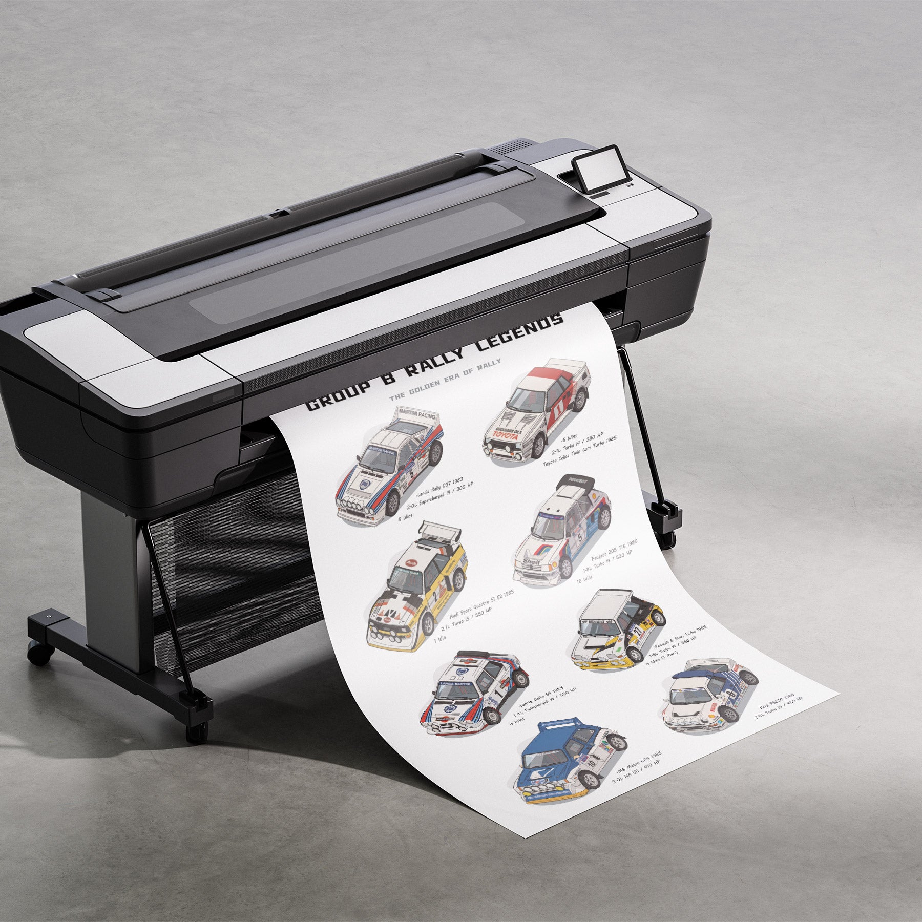 A large black and white wide-format printer on a stand, printing a long sheet featuring illustrated rally cars and the text 'Group B Rally Legends' on a gray studio floor.