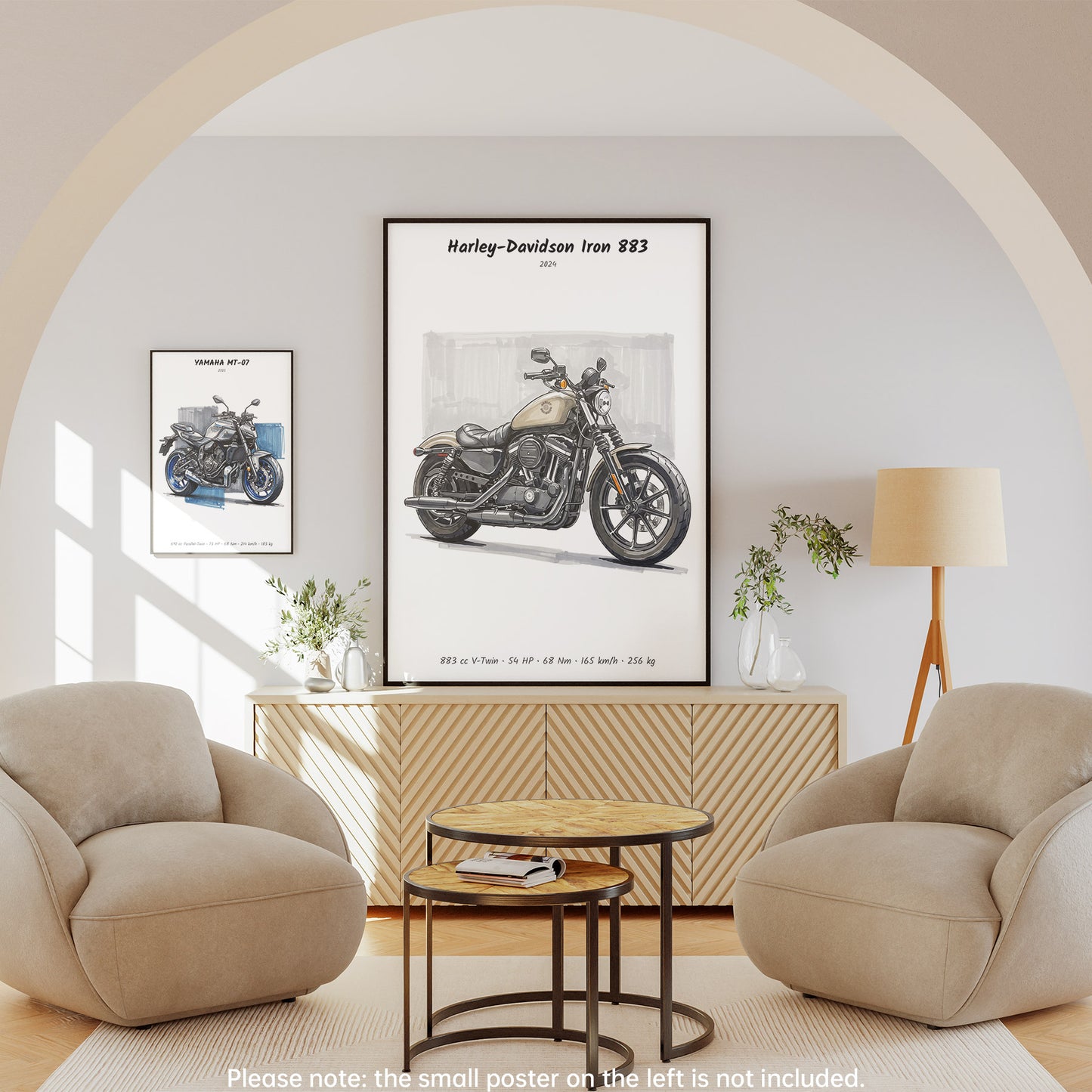 A framed wall poster featuring a vintage Harley-Davidson Iron 883 motorcycle print, displayed in a styled living room setting with two beige armchairs, a round wooden coffee table, and a cream floor lamp.