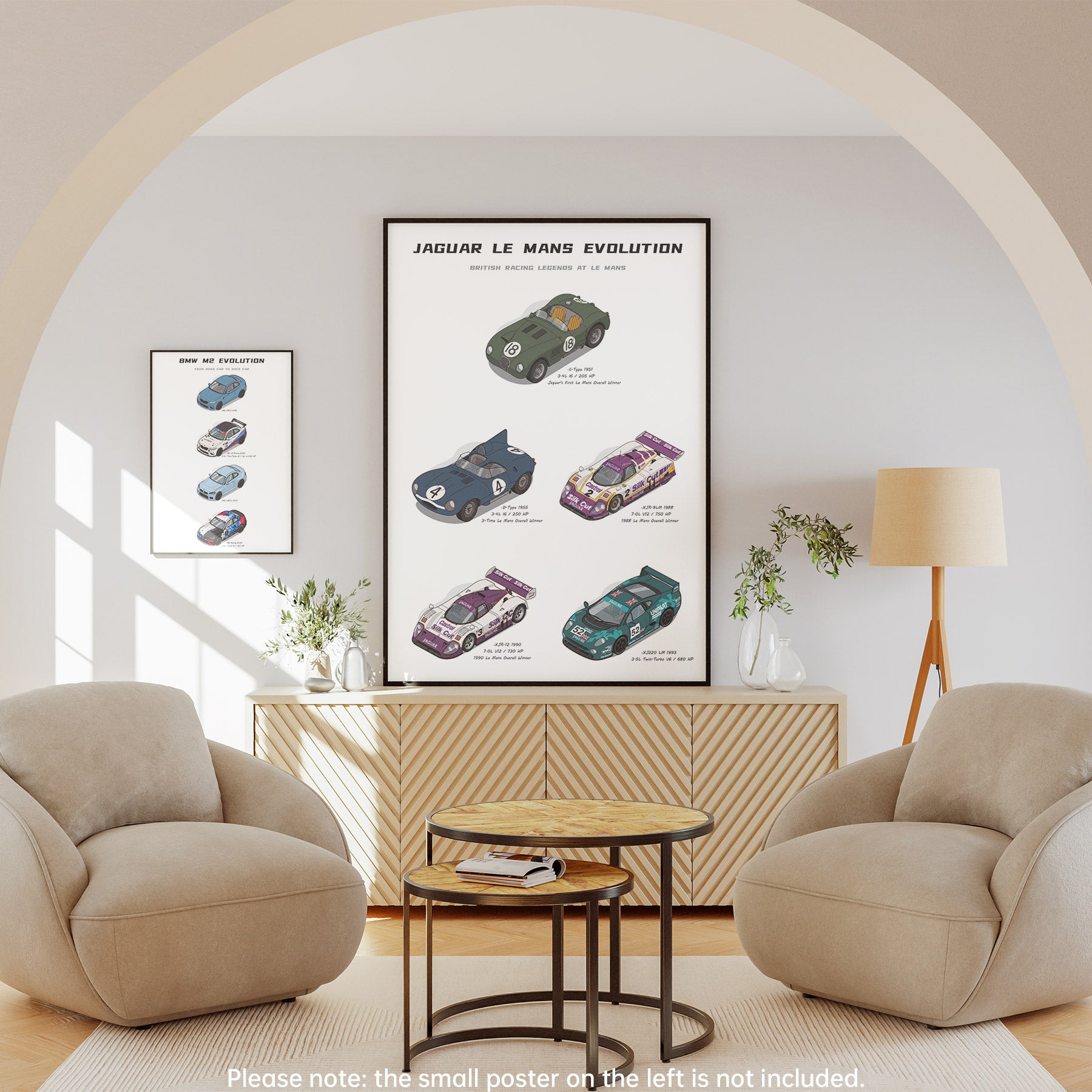 A framed vertical art print titled 'Jaguar Le Mans Evolution' featuring vintage race car illustrations, displayed on a wall in a modern living room setting with two beige armchairs, a wooden cabinet, and a floor lamp.